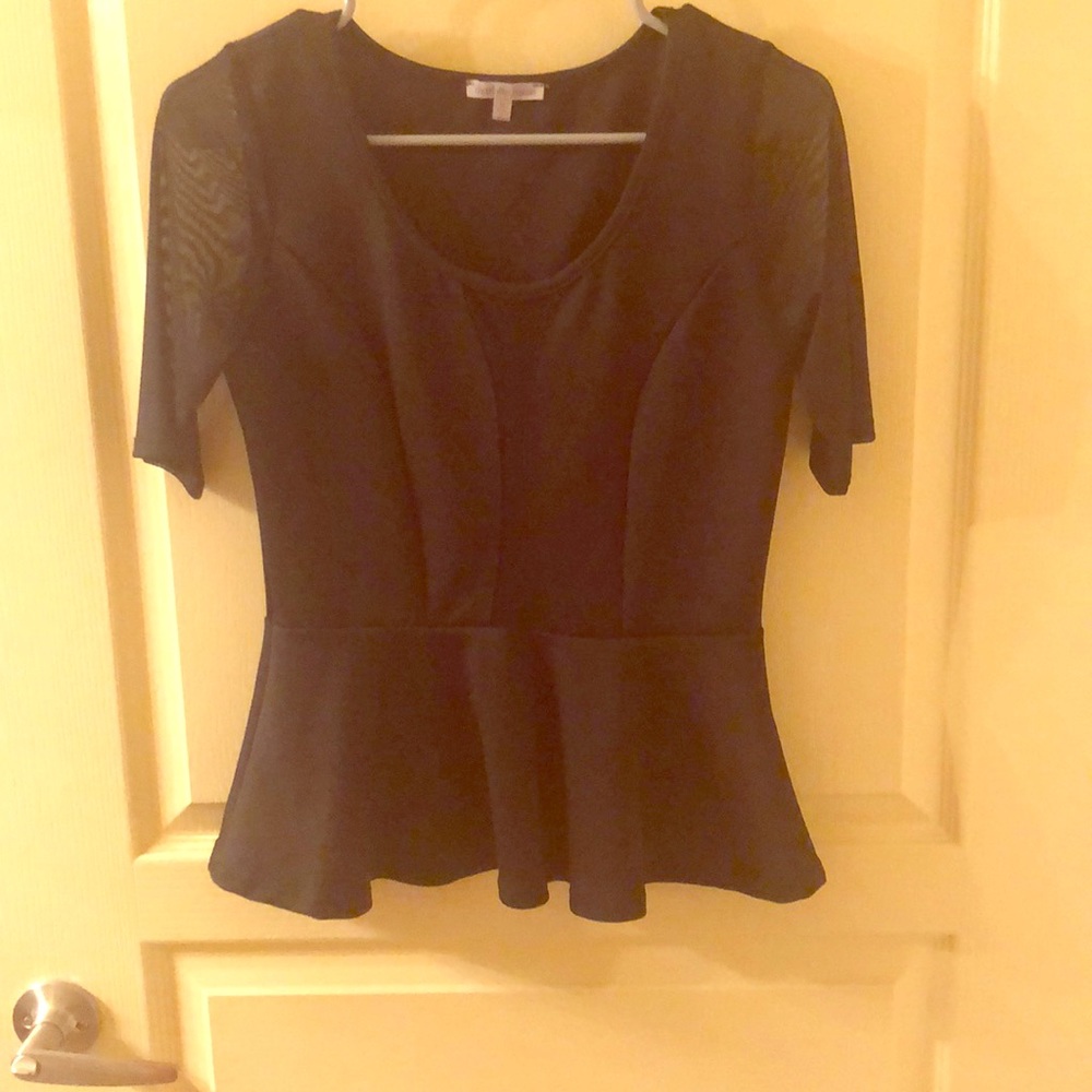 Black top. Sheer arms and sheer cleavage cut out.